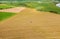 Aerial View Tractor Collects Dry Grass In Straw Bales In Wheat Field. Special Agricultural Equipment. Hay Bales, Hay