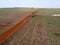 Aerial view of a tractor harrowing the soil to plant soybeans