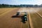 Aerial view of a tractor offloading wheat to truck