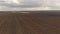 Aerial view tractor plowing farm field for sowing or planting crops