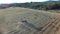 Aerial view of tractor preparing square bales, 4K