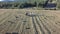 Aerial view of tractor preparing square bales at dusk, 4k