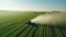 Aerial view of a tractor spraying agricultural fields. spraying herbicides on the field