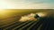 Aerial view of a tractor spraying agricultural fields. spraying herbicides on the field