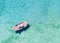 Aerial view of a traditional Greek fishing boat over turquoise sea in Greece