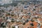 Aerial view of traditional mountain Cyprus village Pano Lefkara with red and orange roofs of buildings, drone photo