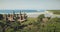 Aerial view of traditional village with ornately houses roof on sand beach sea shore, tropic forest