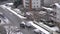 Aerial view of traffic flow and low rise apartment on cold blizzard snow