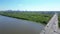 Aerial view of traffic moving on a massive bridge over the Vistula River in Warsaw. Highway passes through the river and leads to