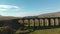 Aerial view of the train going accross Ribblehead viaduct, North Yorkshire, UK