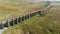 Aerial view of the train going accross Ribblehead viaduct, North Yorkshire, UK