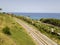 Aerial view of train tracks crossing the coast with sea