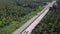 Aerial View of Transport Driving on Road among Palm Tree Plantation. Cinematic Drone Shot Flying over Concrete Road with