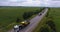 Aerial view. Transportation of combines on road tractors on the road. Oversized transportation. 4k