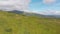 Aerial view of a Traveler with Backpack Climbing along Mountain Slope. Epic Shot