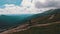 Aerial view of a Traveler with Backpack Climbing along Mountain Slope. Epic Shot