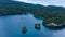 Aerial View Of Triton Bay, Raja Ampat Islands: Boat In Lagoon With Turquoise Water And Green Tropical Trees. Wide Angle Nature