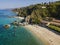 Aerial view of Tropea beach, crystal clear water and rocks that appear on the beach. Calabria, Italy. Swimmers, bathers floating