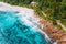 Aerial view of tropical dreamy beach Anse Bazarca, Mahe island, Seychelles. White powdery sand, azure water, lush