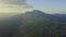 Aerial view of tropical green mountain with small rural village in countryside.