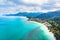 Aerial view of tropical island beach and coastline with transparent turquoise sea water and rainforest landscape, vacation