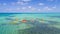 Aerial view of tropical island at Glover`s Reef Atoll in Belize with kayaks