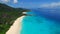 Aerial view of tropical paradise beach with white sand and azure water - Grand Anse, La Digue Island, Seychelles.