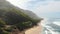 Aerial view of tropical wild beach and ocean with waves.