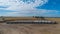 Aerial view of trucks prepared to load corn grains after harvest in the field.