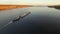 Aerial view of tug boat pushing barge of sand