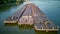 Aerial view of tugboat pushing barges up a river