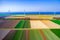 Aerial view of tulips fields in Netherlands with wind mills and blue sea