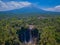 Aerial view of Tumpak Sewu Waterfall and Semeru mountain in Java, Indonesia