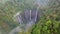 Aerial view of Tumpak Sewu waterfall and Semeru mountain at sunrise located in Lumajang. East Java, Indonesia, November 25, 2022