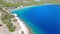 Aerial view of turquoise clear water and sandy beach of Ireon or Limni Vouliagmeni Lake in Peloponnese, Greece