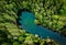Aerial view of a turquoise pond