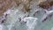 Aerial view of turquoise sea with wave moving to rock stone beach.