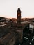 Aerial view of Tuscany cityscape town with an old church, tower and buildings at sunset