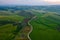 Aerial view of Tuscany rural landscape, road on rolling landscape at sunset, Agriturismo Baccoleno, Asciano, Italy