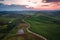 Aerial view of Tuscany rural landscape, road on rolling landscape at sunset, Agriturismo Baccoleno, Asciano, Italy