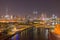 Aerial view of twisted Bridge. Structure of architecture with lake or river, Dubai Downtown skyline, United Arab Emirates or UAE.