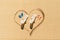 Aerial view of two pair of flip flops, sunbed in shape of heart on sandy tropical beach. Valentines day. Holiday concept. Creative