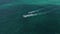 Aerial view of two passenger boats with people sailing in speed in ocean towards destination at beach in Tulum, Mexico