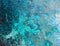 Aerial view of two surfers waiting for waves with crisp, crystal-clear blue ocean beneath them