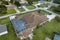 Aerial view of typical contemporary american private house with outside lanai enclosure covering big swimming pool