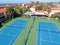 Aerial view of typical south california community condo with tennis court and pool