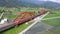 Aerial view of a Tze-chiang Express train traveling thru green paddy fields