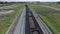 Aerial view UHD 4K of freight train with wagons and standing train with coal