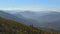 Aerial view of Ukraine. Flight up parallel to the mountain slope, which is covered with an autumn forest.