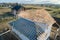 Aerial view of unfinished frame of private house with aerated lightweight concrete walls and wooden roof frame under